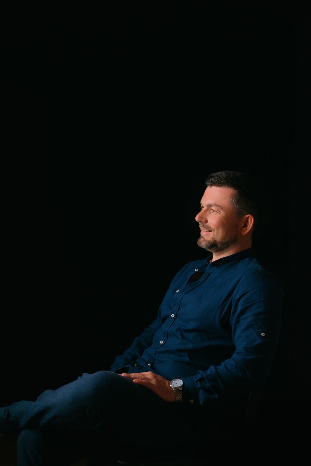 Sam Musayev in profile against a black background